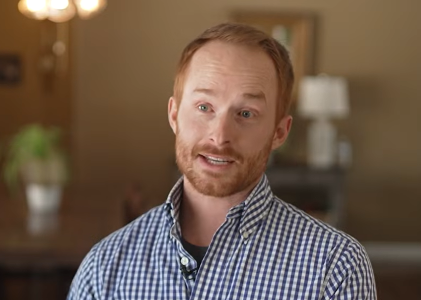 A man talking in a dining room.